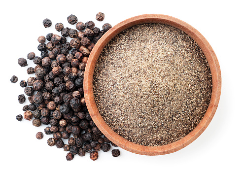 <span  class="uc_style_uc_tiles_grid_image_elementor_uc_items_attribute_title" style="color:#ffffff;">Ground black pepper in a wooden bowl and peppercorns close-up on a white background, isolated. Top view</span>